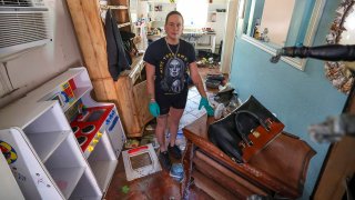 Amanda Normand cleans up the home of Aiden Bowles who died in the home during flooding from Hurricane Helene on Wednesday, Oct. 2, 2024, in Indian Rocks Beach, Fla.