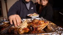 The head of the cabrito is seen as guests make their plates during a carne asada. (Juan Figueroa/The Dallas Morning News)