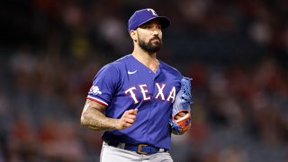 ANAHEIM, CALIFORNIA – JULY 29: Matt Bush #51 of the Texas Rangers runs to first base after a base hit from the Los Angeles Angels during the ninth inning at Angel Stadium of Anaheim on July 29, 2022 in Anaheim, California. (Photo by Michael Owens/Getty Images)