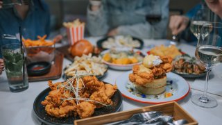 close up comfort food on dining table in social gathering with friends at restaurant