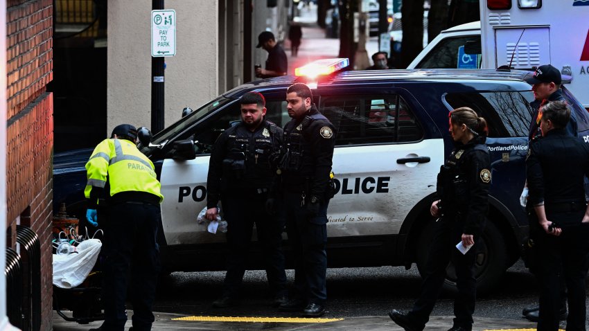 Portland Police officers look on as American Medical Response (AMR) paramedics transport a patient after they were administered Narcan brand Naloxone nasal spray for a suspected fentanyl drug overdose in Portland, Oregon, on January 25, 2024.