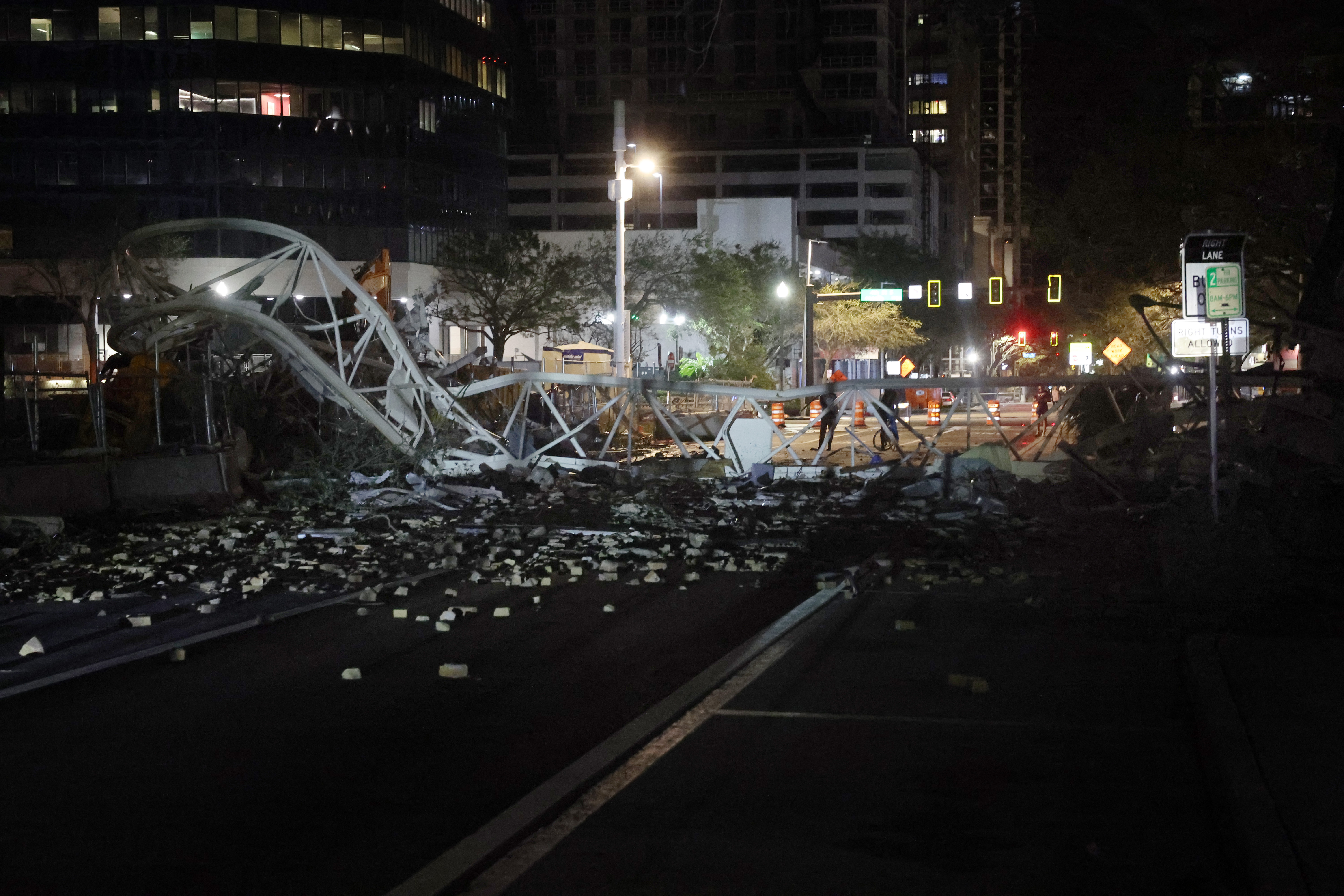 A crane sits on the street after crashing down into the building housing the Tampa Bay Times offices after the arrival of Hurricane Milton on October 10, 2024 in St. Petersburg, Florida.