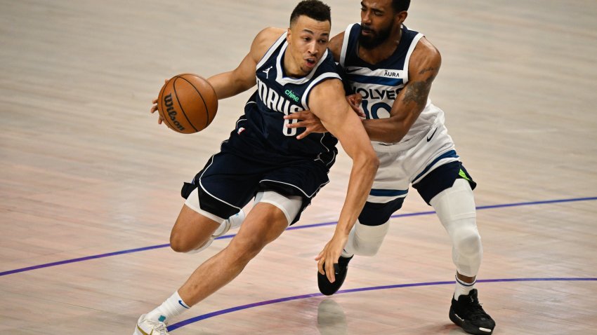 May 28, 2024; Dallas, Texas, USA; Dallas Mavericks guard Dante Exum (0) dribbles against Minnesota Timberwolves guard Mike Conley (10) during the second quarter of game four of the western conference finals for the 2024 NBA playoffs at American Airlines Center. Mandatory Credit: Jerome Miron-USA TODAY Sports