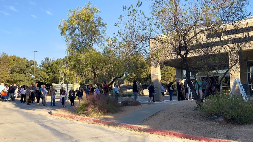 Voters line up outside the Ron Wright Library to vote early, Oct. 21, 2024.