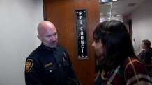 Fort Worth Chief of Police Neil Noakes, left, apologizes to a victim of sexual assault over the delay in testing her rape kit, Tuesday, Oct. 22, 2024.