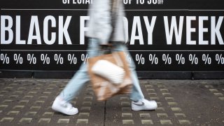 Shoppers walk through the retail district near Oxford Circus as the annual Black Friday sale event arrives. In-store Black Friday spending is expected to grow by 7.3 per cent in the UK this year. 