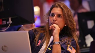 Traders work on the floor of the New York Stock Exchange during afternoon trading on Aug. 2, 2024.