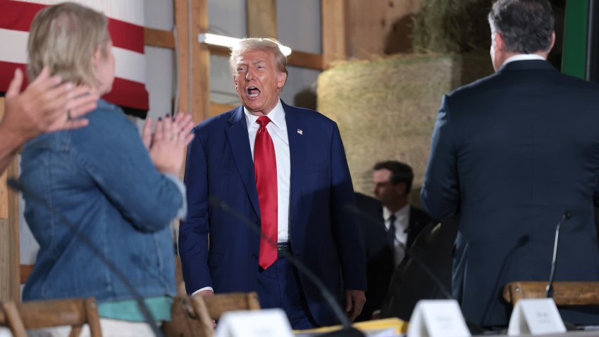 Republican presidential nominee, former U.S. President Donald Trump, (C) greets attendees during a campaign stop to address Pennsylvanians who are concerned about the threat of Communist China to U.S. agriculture at the Smith Family Farm September 23, 2024 in Smithton, Pennsylvania. 