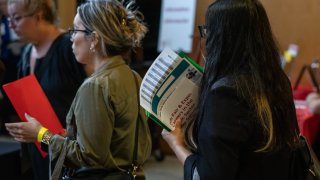 A jobseeker holds flyers during the New York Public Library’s annual Bronx Job Fair & Expo at the the Bronx Library Center in the Bronx borough of New York, US, on Friday, Sept. 6, 2024. 