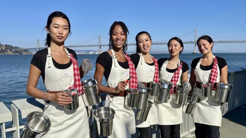 Hannah Chea (center) is considering turning her side gig of shucking oysters for parties into her full-time gig after being laid off from her tech job.