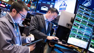 Traders work on the floor of the New York Stock Exchange. 