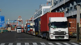 A line of trucks parked outside a shipping terminal in Yokohama, Japan, on Monday, Dec. 4, 2023. 