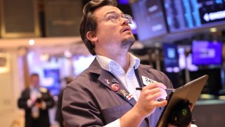 Traders work on the floor of the New York Stock Exchange during morning trading on November 26, 2024 in New York City.