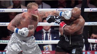 Jake Paul lands a left to Mike Tyson during their heavyweight boxing match, Friday, Nov. 15, 2024, in Arlington, Texas. (AP Photo/Julio Cortez)