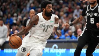 Dallas Mavericks guard Kyrie Irving drives the lane past San Antonio Spurs guard Stephon Castle (5) during the first half of an NBA basketball game Saturday, Nov. 16, 2024, in Dallas. (AP Photo/Jeffrey McWhorter)