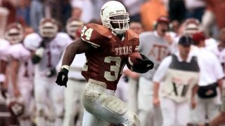 FILE – Texas running back Ricky Williams breaks the all-time NCAA college rushing record as he runs past the Texas A&M bench for a 60-yard touchdown during the first quarter in Austin, Texas, Nov. 27, 1998.