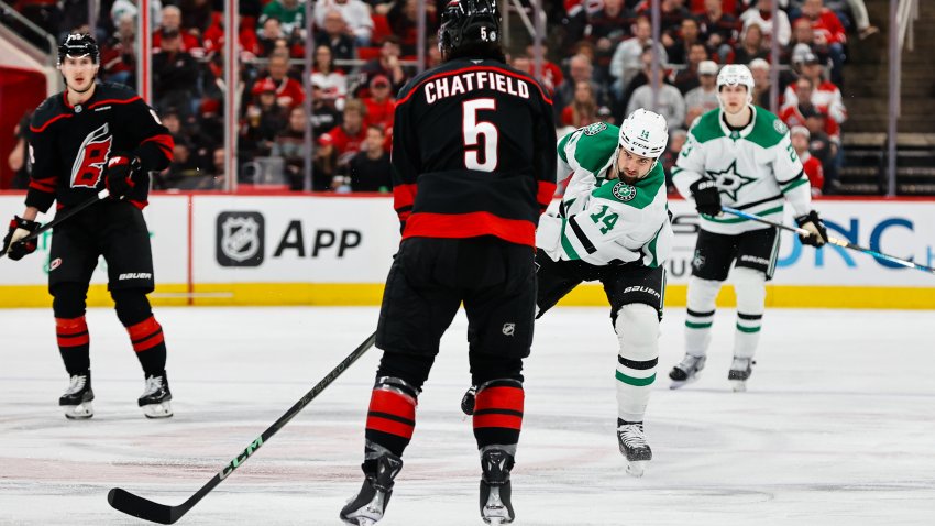 RALEIGH, NC – NOVEMBER 25: Jamie Benn #14 of the Dallas Stars shoots the puck past Jalen Chatfield #5 of the Carolina Hurricanes during the third period of the game at Lenovo Center on November 25, 2024 in Raleigh, North Carolina.