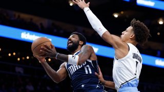 ATLANTA, GEORGIA – NOVEMBER 25: Kyrie Irving #11 of the Dallas Mavericks goes up for a shot against Jalen Johnson #1 of the Atlanta Hawks during the first half at State Farm Arena on November 25, 2024 in Atlanta, Georgia.