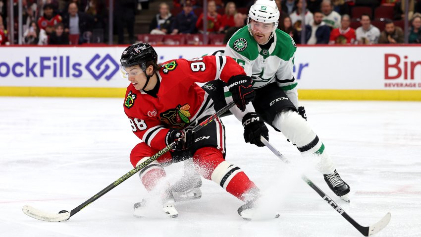 CHICAGO, ILLINOIS – NOVEMBER 27: Connor Bedard #98 of the Chicago Blackhawks fights for control of the puck against Thomas Harley #55 of the Dallas Stars during the second period at the United Center on November 27, 2024 in Chicago, Illinois.