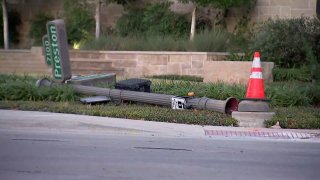 A street sign is down at the intersection where a five-vehicle collision left one dead  and one hospitalized.