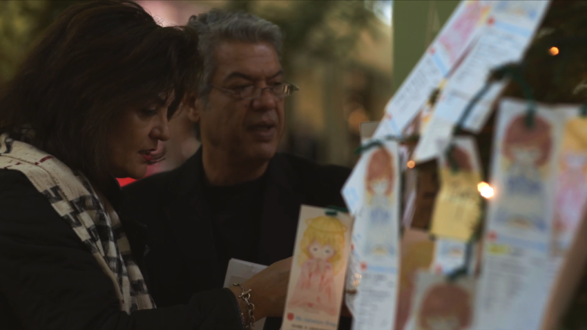 Hispanic couple selecting an Angel from the Salvation Army Angel Tree