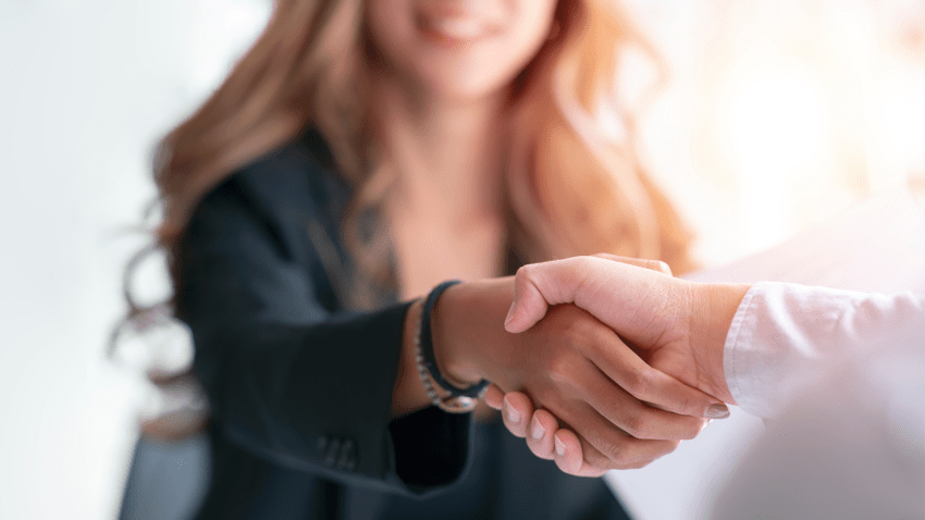 Business woman shaking hands adobe stock