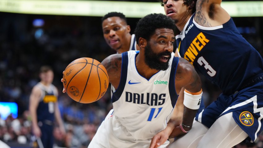 Nov 10, 2024; Denver, Colorado, USA; Dallas Mavericks guard Kyrie Irving (11) drives around Denver Nuggets guard Julian Strawther (3) in the second half at Ball Arena. Mandatory Credit: Ron Chenoy-Imagn Images