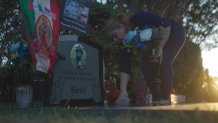 Lilia Astudillo tends to the grave of her 14-year-old son Beto.