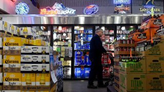 A customer walks past the beer coolers at Chambers Wine and Liquor in Aurora, Colorado.