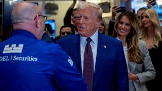 President-elect Donald Trump walks onto the floor of the New York Stock Exchange (NYSE) with his wife Melania, after being named TIME’s “Person of the Year” for the second time on December 12, 2024 in New York City. 