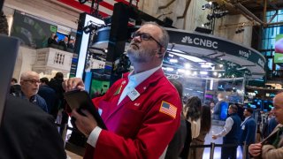 Traders work on the New York Stock Exchange floor on Dec. 18, 2024.