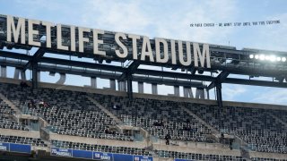 A plan pulls a banner, directed at New York Giants owner John Mara, over Met Life Stadium