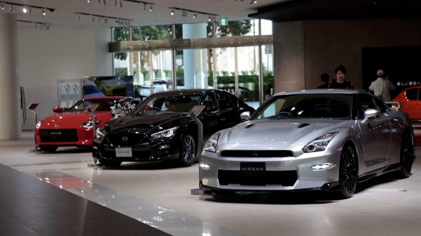 A line of Nissan cars in a showroom.