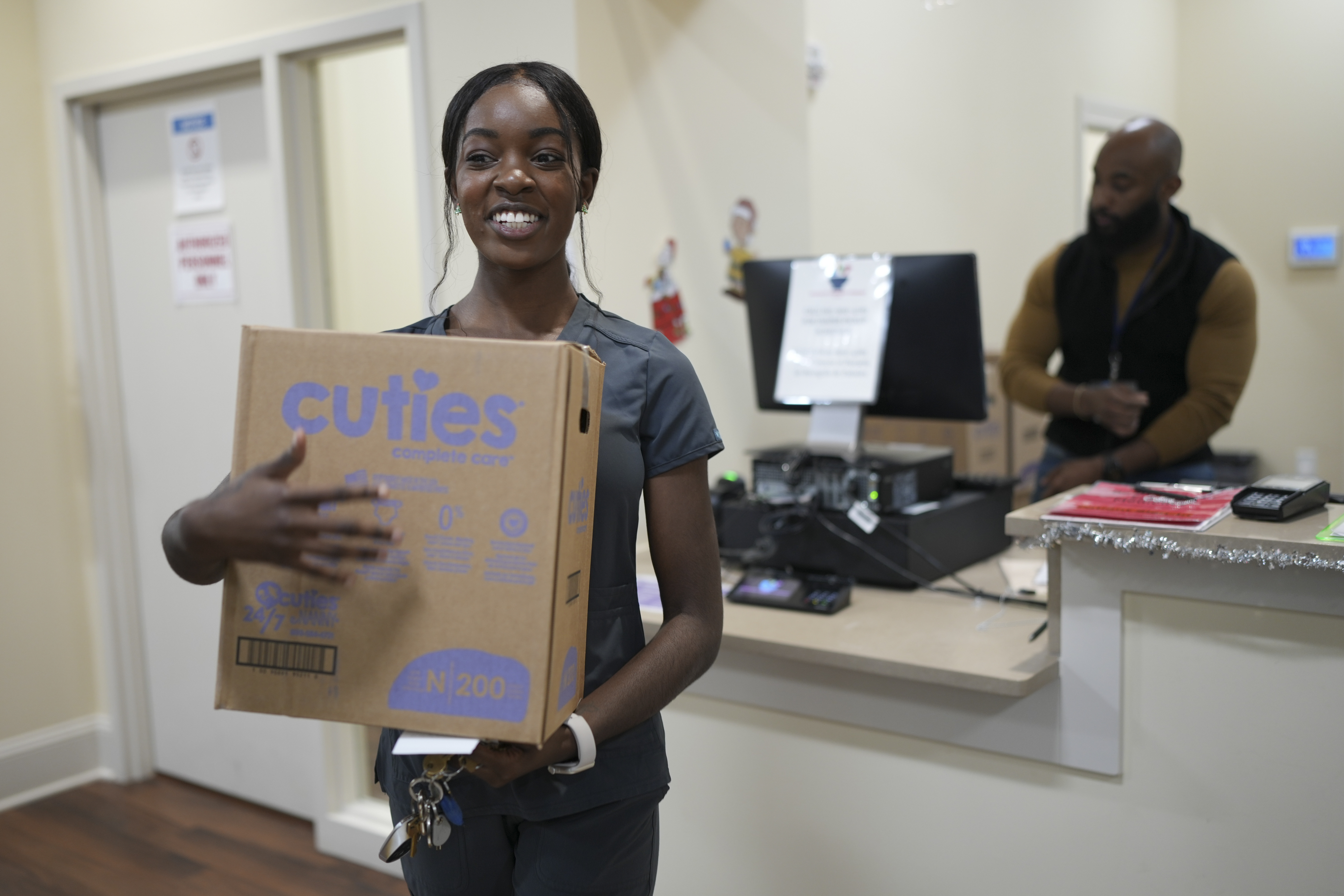 Tatayanna Johnson carries a box of diapers