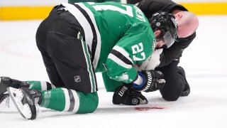 Dallas Stars left wing Mason Marchment (27) is tended to after he was hit by the puck during the first period of an NHL hockey game against the Minnesota Wild, Friday, Dec. 27, 2024, in Dallas. (AP Photo/LM Otero)