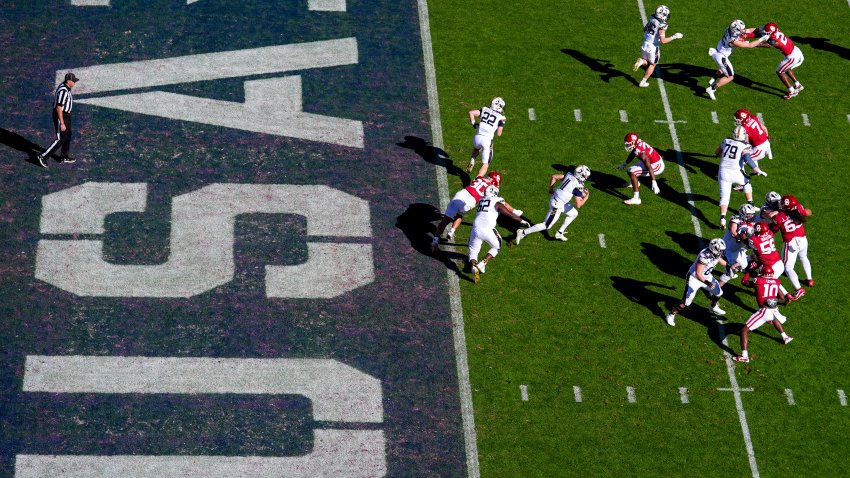 Navy quarterback Blake Horvath, center, runs with the ball on his way to a 95-yard touchdown run during the second half of the Armed Forces Bowl NCAA college football game against Oklahoma, Friday, Dec. 27, 2024, in Fort Worth, Texas. Navy won 21-20. (AP Photo/Julio Cortez)