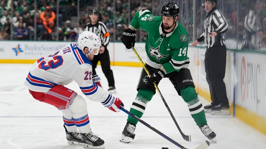 DALLAS, TX – DECEMBER 20: Jamie Benn #14 of the Dallas Stars makes a pass to a teammate against Adam Fox #23 of the New York Rangers at the American Airlines Center on December 20, 2024 in Dallas, Texas.