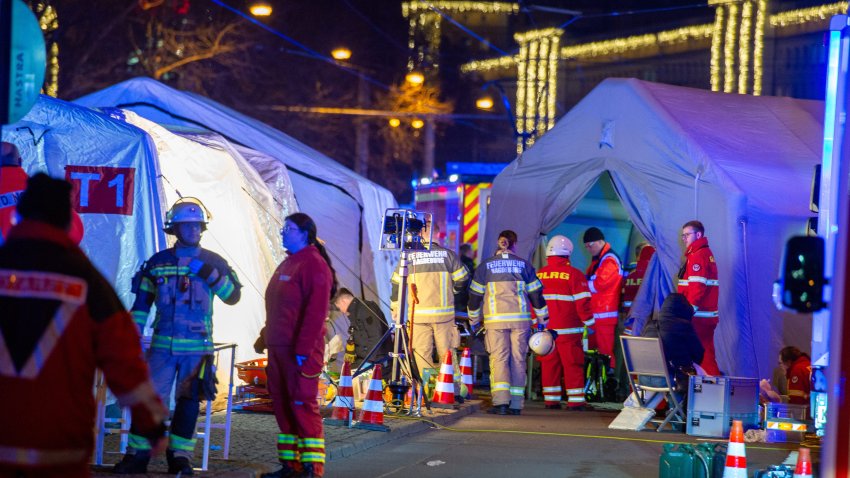 Police vans and ambulances stand next to the annual Christmas market in the city center following a suspected attack on Dec. 20, 2024, in Magdeburg, Germany.