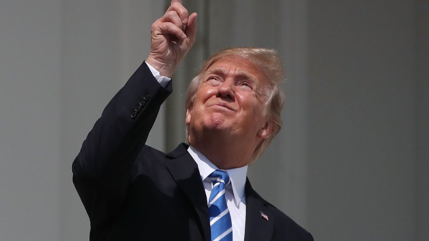 WASHINGTON, DC – AUGUST 21:  U.S. President Donald Trump looks up toward the Solar Eclipse on the Truman Balcony at the White House on August 21, 2017 in Washington, DC. Millions of people have flocked to areas of the U.S. that are in the “path of totality” in order to experience a total solar eclipse.