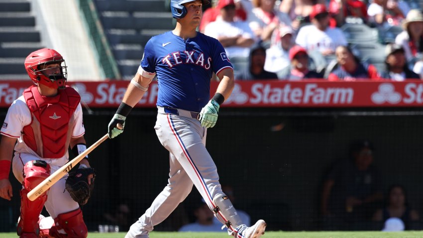 Sep 29, 2024; Anaheim, California, USA;  Texas Rangers first baseman Nathaniel Lowe (30) hits a home run during the eighth inning against the Los Angeles Angels at Angel Stadium. Mandatory Credit: Kiyoshi Mio-Imagn Images