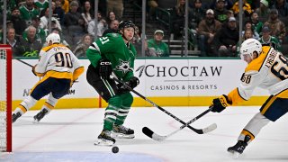 Dec 12, 2024; Dallas, Texas, USA;  Nashville Predators left wing Zachary L’Heureux (68) scores an empty net goal past Dallas Stars left wing Jason Robertson (21) during the third period at the American Airlines Center. Mandatory Credit: Jerome Miron-Imagn Images