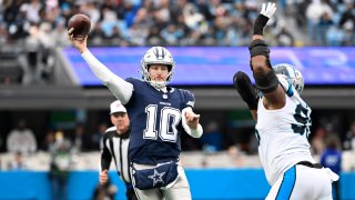 Dec 15, 2024; Charlotte, North Carolina, USA;  Dallas Cowboys quarterback Cooper Rush (10) throws a touchdown pass as Carolina Panthers defensive end LaBryan Ray (93) pressures in the third quarter at Bank of America Stadium. Mandatory Credit: Bob Donnan-Imagn Images