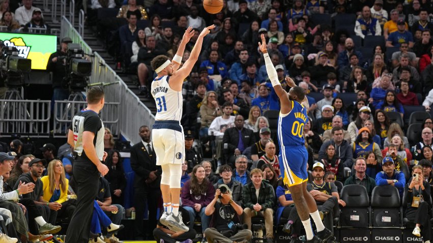 Dec 15, 2024; San Francisco, California, USA; Dallas Mavericks guard Klay Thompson (31) shoots against Golden State Warriors forward Jonathan Kuminga (00) during the fourth quarter at Chase Center. Mandatory Credit: Darren Yamashita-Imagn Images