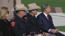 Col. Freeman Martin, left, sits with retired director of the Texas DPS, Col. Steve McCraw, center, and Gov. Greg Abbott, right, at a change of command ceremony in Austin, Texas, Monday, Dec. 2, 2024.