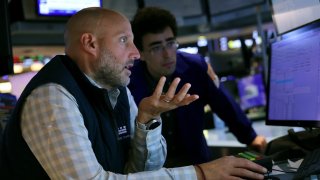 Traders work on the floor of the New York Stock Exchange in New York City.