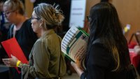 A jobseeker holds flyers during the New York Public Library’s annual Bronx Job Fair & Expo at the the Bronx Library Center in the Bronx borough of New York, US, on Friday, Sept. 6, 2024.