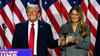 Former U.S. President and Republican presidential candidate Donald Trump and former first lady Melania Trump smile after speaking during an election night event at the West Palm Beach Convention Center in West Palm Beach, Florida, early on Nov. 6, 2024.