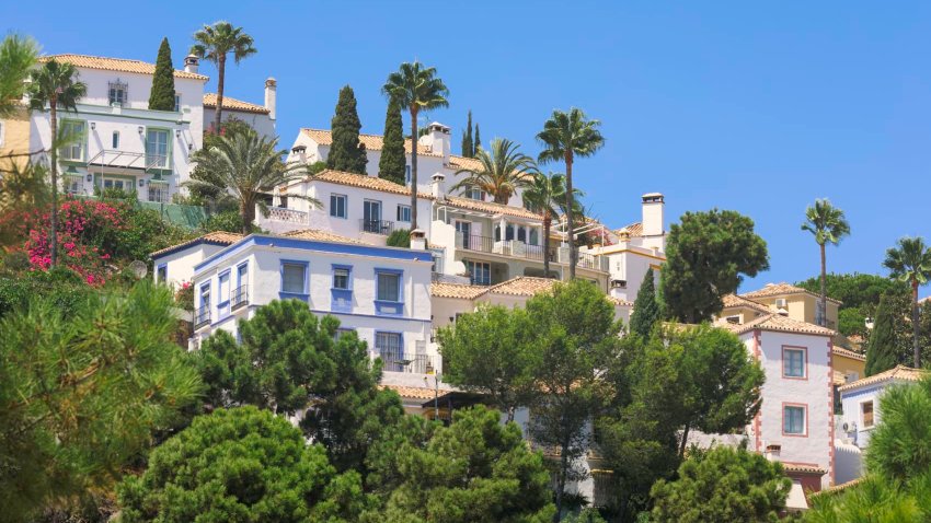 Houses along a hillside outside Marbella on the sunny coast, Costa del Sol, in Spain.