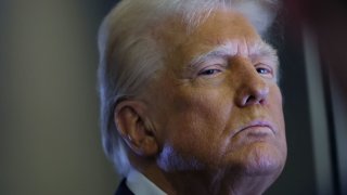 U.S. President Donald Trump looks on as reporters ask questions aboard Air Force One during a flight from Las Vegas, Nevada, to Miami, Florida, U.S., January 25, 2025. 