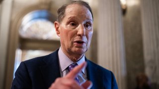 Sen. Ron Wyden, D-Ore., talks with reporters during a senate vote in the U.S. Capitol on Wednesday, Dec. 18, 2024.